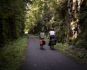 Two bike tourists passing by on the HVRT in one of several fern-lined stone cutouts.