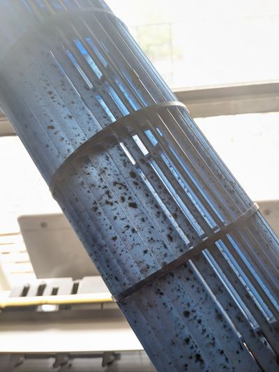 A photograph of mold on the cylindrical blower fan of a Midea u-shaped air conditioner