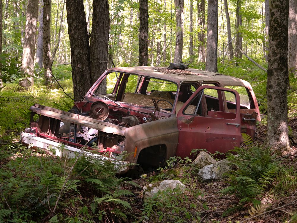 An abandoned Chevy Suburban in a ditch