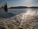 the tattered American flag on the Haverstraw-Ossining ferry and its wake