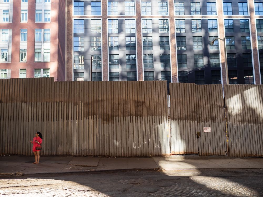 A non-plussed woman under the Manhattan Bridge in DUMBO