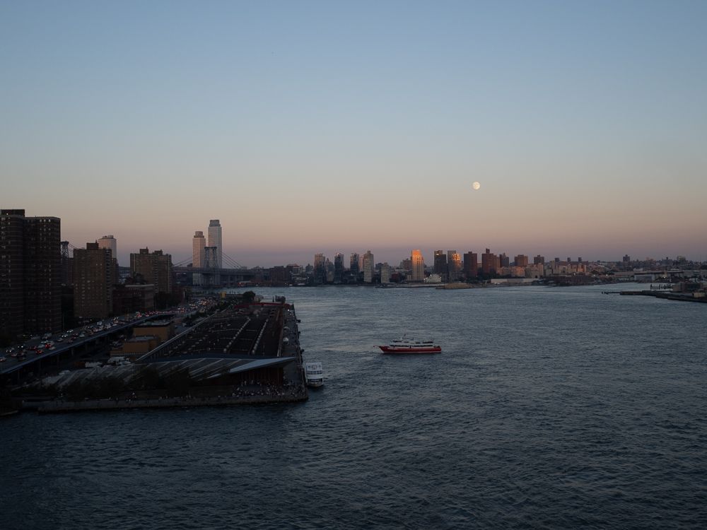 waxing moonrise over the East River from the Manhattan bridge bike path
